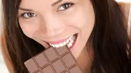 Happy Woman Eating Large Chocolate Bar