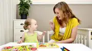 Mom Helping Child With Puzzle