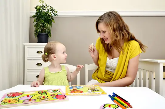 Mom Helping Child With Puzzle