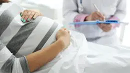 Young Pregnant Woman With Doctor